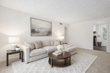 Riverdale apartment for rent - A living room with a white couch, a coffee table, and a painting on the wall.