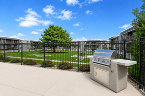 Midvale apartment for rent - A BBQ grill is in the middle of a concrete patio.