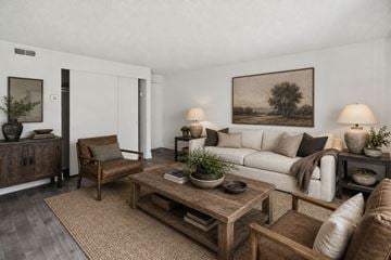 Midvale apartment for rent - A living room with a white couch, a wooden coffee table, and a painting on the wall.