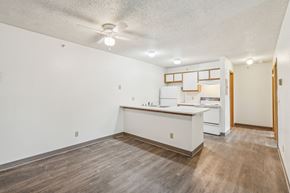 Billings apartment for rent - A kitchen with white cabinets and a wooden island.