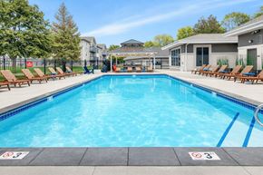 Waite Park apartment for rent - Outdoor swimming pool with sundeck and lounge chairs at Prosper West Apartments, Waite Park, Minnesota