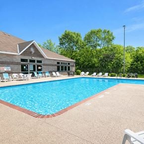St Cloud apartment for rent - A pool with a building behind it.