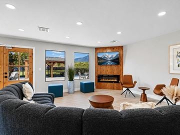 West Valley City apartment for rent - A living room with a grey couch and a wooden fireplace.