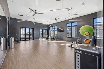 Fitness center with cardio equipment and natural light