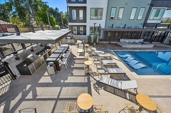 Outdoor pool deck with lounge seating and grilling stations