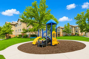 Provo apartment for rent - A playground with a blue and yellow slide in the middle of a circular play area at Slate Canyon Apartments, Utah, 84606