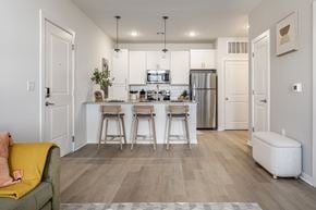 Kansas City apartment for rent - A kitchen with white cabinets and a refrigerator.