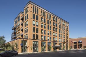 Minneapolis apartment for rent - A large brick building with a balcony on the top floor.