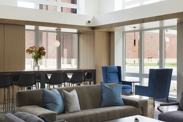 Minneapolis apartment for rent - A living room with a grey couch and blue chairs.