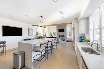 Community room kitchen with island and barstools