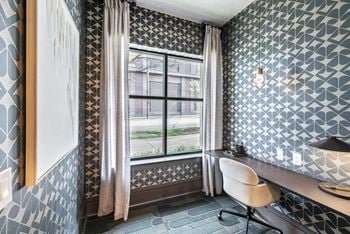 A small room with a desk and a window