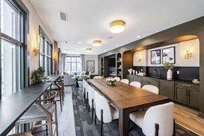 Charlotte apartment for rent - a dining room with a long wooden table and white chairs at Park & Kingston, Charlotte NC 28203