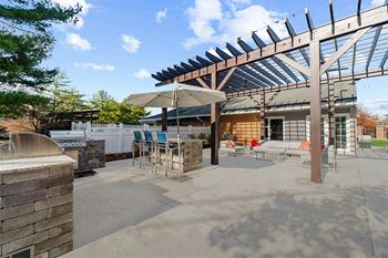 Outdoor kitchen with grilling stations and seating 