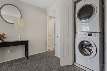A small laundry room with a washer and dryer