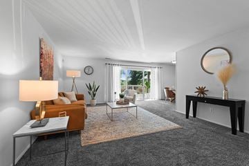 Towson apartment for rent - A living room with a grey carpet and a brown sofa.