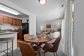 Towson apartment for rent - A modern dining room with a wooden table and chairs.