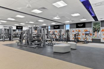A gym with weights and other exercise equipment on the floor