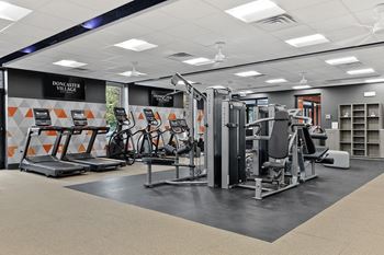 A gym with cardio machines and other exercise equipment
