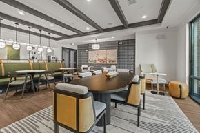 Charlotte apartment for rent - A modern clubroom with a large table and chairs. at 1010 Dilworth Apartments, Charlotte