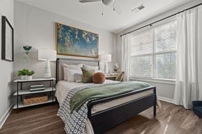 Charlotte apartment for rent - A bedroom with a large bed and a painting on the wall. at 1010 Dilworth Apartments, Charlotte 28204