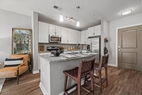 Charlotte apartment for rent - A kitchen with a counter and chairs. at 1010 Dilworth Apartments, Charlotte, NC
