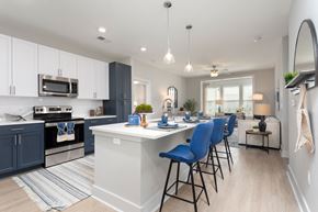 Bluffton apartment for rent - an open kitchen with an island and blue bar stools at Bristol at New Riverside, Bluffton