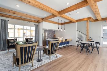 A dining room and living room with a table and chairs