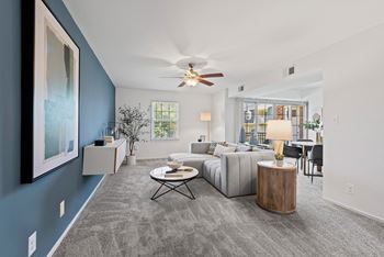 A living room with a couch and a ceiling fan