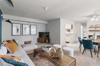 A living room and dining room with a couch and a table