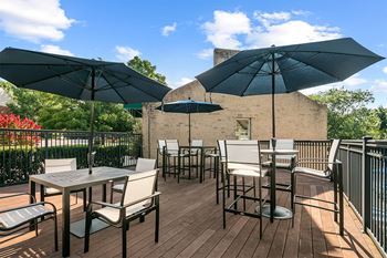 An outdoor patio with tables and chairs and umbrellas