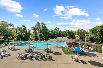 A swimming pool with chairs and umbrellas at the resort