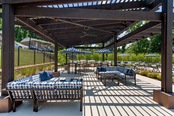 A patio with couches and tables and umbrellas