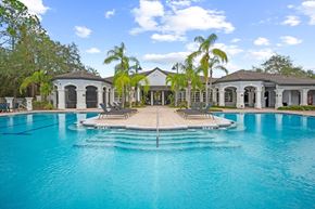 Tampa apartment for rent - A large swimming pool in front of a house at The Grand Reserve at Tampa Palms Apartments, Florida, 33647
