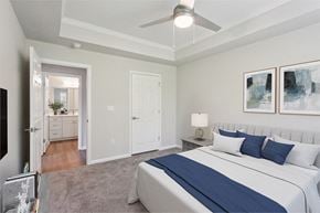 Bluffton apartment for rent - a bedroom with a large bed and a ceiling fan at The Bluestone Apartments, South Carolina