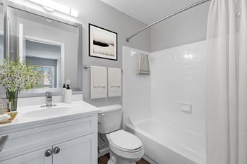 A white bathroom with a shower and a sink