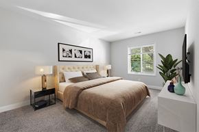 Timonium apartment for rent - a bedroom with grey walls and a large bed  with a brown blanket at Padonia Village Apartments, Timonium MD