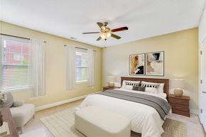 Asheville apartment for rent - A bedroom with a bed, nightstands, and a ceiling fan at The Lofts at Reynolds Village Apartments, North Carolina, 92627