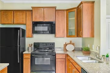 Asheville apartment for rent - A kitchen with black appliances and wooden cabinets.