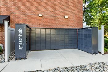 Amazon hub package lockers in front of a brick building