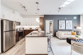 A kitchen and living room with stainless steel appliances