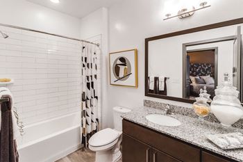 A bathroom with a shower and a sink and a mirror
