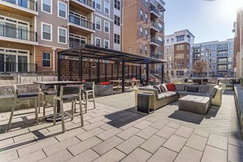 A large patio with tables and chairs in front of a building