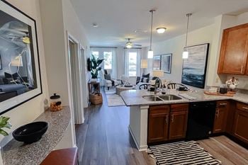 Open living area kitchen looking into bedroom 