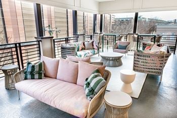 A rooftop seating area with couches and tables