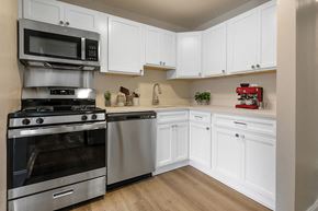 Timonium apartment for rent - a kitchen with white cabinets and stainless steel appliances at Padonia Village Apartments, Timonium MD
