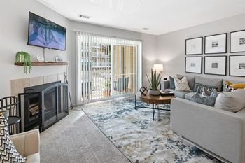 An open living room with a fireplace and a sliding glass door
