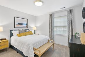 Owings Mills apartment for rent - a bedroom with a bed and a window at McDonogh Township Apartments, Owings Mills, MD, 21117
