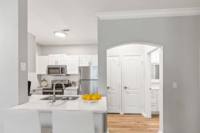 Mount Pleasant apartment for rent - A kitchen with white cabinets and a white island with a bowl of lemons on it at Sweetgrass Landing, Mount Pleasant, SC