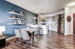 Davidson apartment for rent - A kitchen with a table and chairs in front of a blue wall at The Linden Apartments, North Carolina