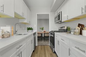 Towson apartment for rent - a kitchen with white cabinets and stainless steel appliances  at Courthouse Square Apartments, Towson, MD, 21286